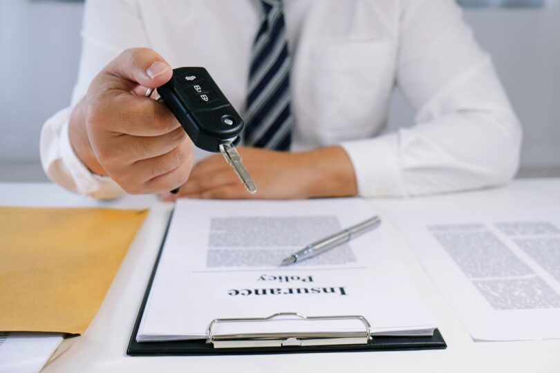 midsection of insurance agent holding car key at royalty free image 1583601241 810x540